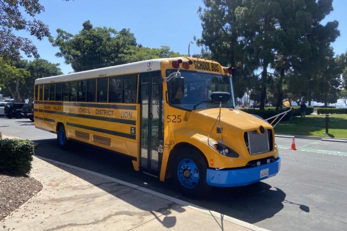 An electric school bus parked on the street