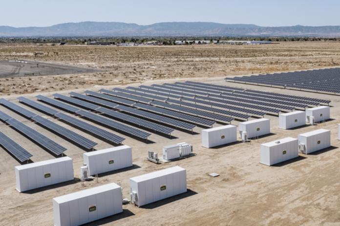 A field of solar panels with onsite battery storage.