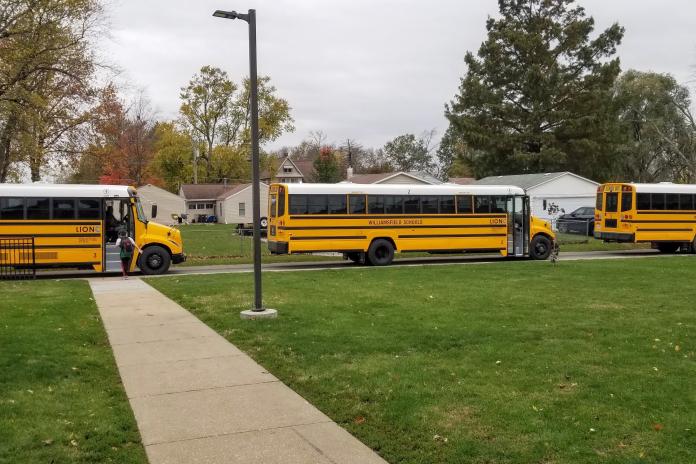 Electric school buses lined up in Williamsfield, Ill. -- credit Tim Farquer