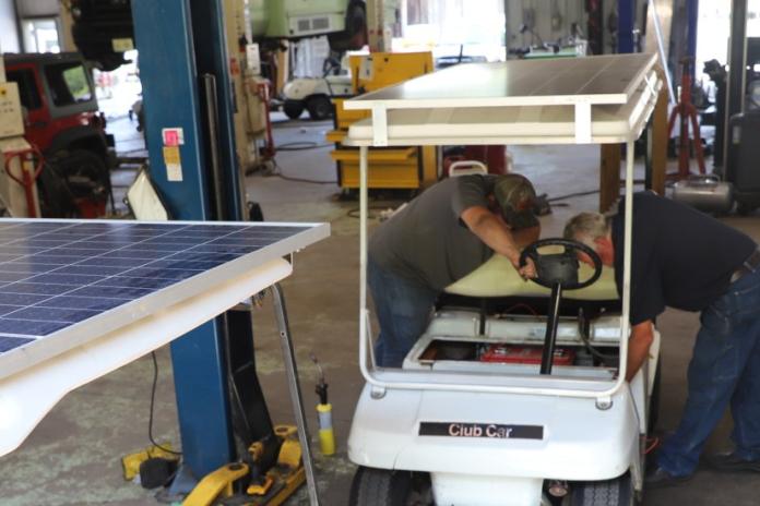 Cliff Cochran, Cherokee Boys Club vehicle technician, instructing a high school intern.