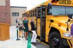 Passengers board an electric school bus during a ride and drive event at Lake Shore Central School District.