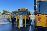 Electric school buses charging in a lot. 