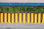 Electric school buses in a parking lot, seen from overhead.