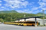 ESBs under solar canopy in front of mountains at Cherokee - WRI's Electric School Bus Initiative