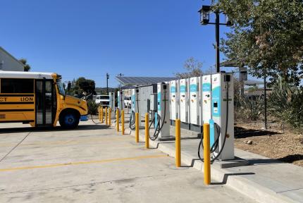 An electric school bus charging at Cajon Valley.
