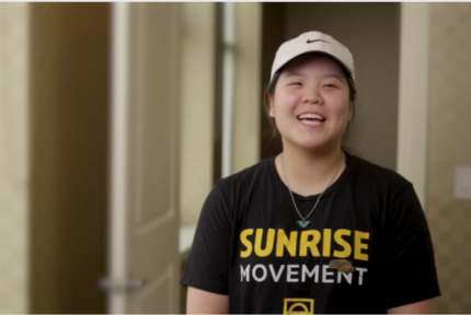 Smiling girl in t-shirt and hat.