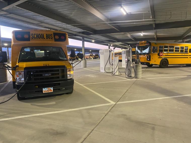 Electric school buses charge.