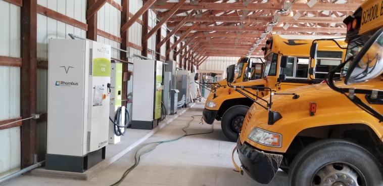 Williamsfield’s electric school buses charge at the depot.
