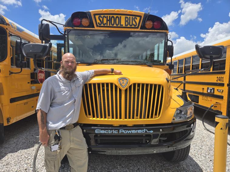 School bus driver Thomas Wondrock appreciates the quieter rides and improved communication that electric buses provide. Photo by Ron Reser. 