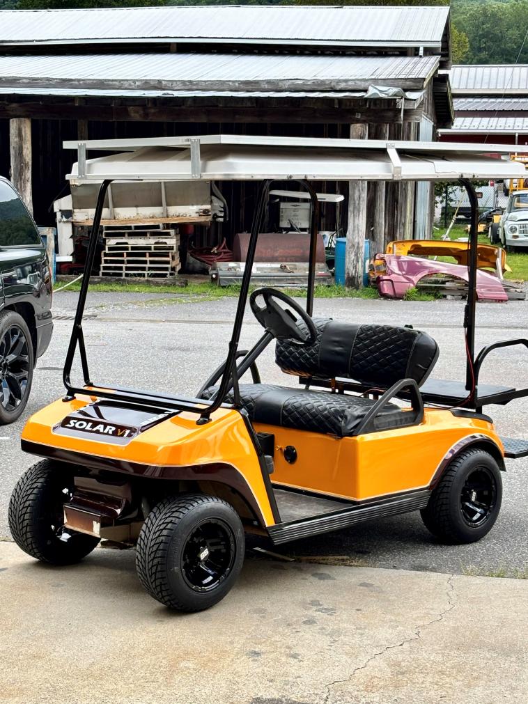 A beautiful yellow golf cart