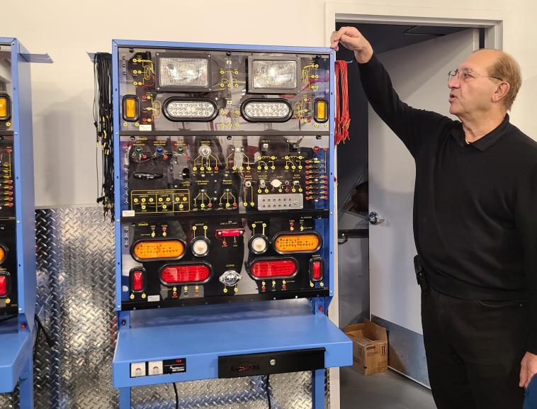 Clement Drummond, Director of Automotive Technology at Bronx Community College, showing a training platform for automotive students in the Patterson Garage. Photo by Stephanie Ly/WRI